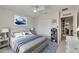 Cozy bedroom showcases a comfortable bed with a beach-themed accent, closet, and doorway at 9665 Sweetwell Pl, Riverview, FL 33569