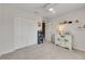 Bedroom with neutral walls, carpet, ceiling fan, closet, hallway view, and tropical dresser decor at 9665 Sweetwell Pl, Riverview, FL 33569