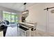 Dining area with a modern light fixture and sliding glass doors leading to a screened patio at 9665 Sweetwell Pl, Riverview, FL 33569