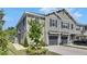 Stylish townhome featuring neutral siding, dark shutters, and attached single-car garage at 9665 Sweetwell Pl, Riverview, FL 33569
