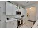 Stylish kitchen with white cabinets, modern appliances, and plenty of counter space at 9665 Sweetwell Pl, Riverview, FL 33569