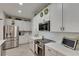 Modern kitchen boasting stainless steel appliances, ample cabinetry and stylish countertops at 9665 Sweetwell Pl, Riverview, FL 33569