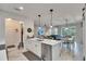 Open-concept kitchen with island seating flows into the living and dining areas at 9665 Sweetwell Pl, Riverview, FL 33569
