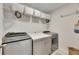 Laundry room featuring modern washer and dryer, a countertop, storage cabinets, and decorative baskets at 9665 Sweetwell Pl, Riverview, FL 33569