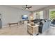 The living room offers tile floors, a ceiling fan, and sliding glass doors to the backyard at 9665 Sweetwell Pl, Riverview, FL 33569