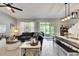 Open living area leads to the backyard through sliding glass doors, complemented by a dining area at 9665 Sweetwell Pl, Riverview, FL 33569