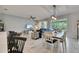 Bright living room with tile floors, a ceiling fan, and sliding glass doors to the backyard at 9665 Sweetwell Pl, Riverview, FL 33569