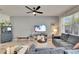 Living room featuring a ceiling fan, natural light, and stylish decor at 9665 Sweetwell Pl, Riverview, FL 33569