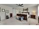 Bright main bedroom with neutral carpet, a ceiling fan, and modern decor at 9665 Sweetwell Pl, Riverview, FL 33569