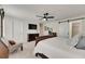 Main bedroom featuring neutral carpet, ceiling fan, and barn door entry to main bathroom at 9665 Sweetwell Pl, Riverview, FL 33569