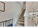 Bright stairway with carpet, white walls, and an open view to the kitchen with island at 9665 Sweetwell Pl, Riverview, FL 33569
