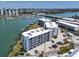 Aerial view of Madeira Beach Florida waterfront condo building overlooking marina and bay at 9815 Harrell Ave # 503, Treasure Island, FL 33706