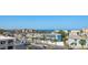 Aerial view showcasing a blue home nestled near the ocean and the surrounding streets at 9815 Harrell Ave # 503, Treasure Island, FL 33706