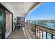 Outdoor balcony with seating and view of waterway and community pool below at 9815 Harrell Ave # 503, Treasure Island, FL 33706