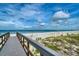 Beach access to Treasure Island beach over boardwalk with beach vegetation at 9815 Harrell Ave # 503, Treasure Island, FL 33706