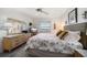 Well-lit bedroom with ceiling fan, complemented by a dresser, and a window with outside views at 9815 Harrell Ave # 503, Treasure Island, FL 33706