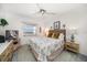 Bright bedroom features a ceiling fan, dresser, and a window offering a view to the outside at 9815 Harrell Ave # 503, Treasure Island, FL 33706