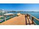 Waterfront property featuring a private dock and boat lift and waterfront views with outdoor seating at 9815 Harrell Ave # 503, Treasure Island, FL 33706