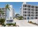 Complex exterior showcasing multiple units, lush landscaping, and signage at 9815 Harrell Ave # 503, Treasure Island, FL 33706
