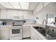 Well-lit kitchen boasts white appliances, ample cabinet space, and a convenient breakfast bar at 9815 Harrell Ave # 503, Treasure Island, FL 33706