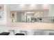 Bright kitchen features white cabinetry, a breakfast bar and tiled backsplash at 9815 Harrell Ave # 503, Treasure Island, FL 33706