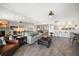 Bright living room features a mirrored wall, hardwood floors, and comfortable seating adjacent to the bar at 9815 Harrell Ave # 503, Treasure Island, FL 33706