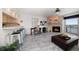 Living room with fireplace, bar stool seating to the kitchen, and views from the balcony at 9815 Harrell Ave # 503, Treasure Island, FL 33706