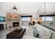 Living room with stone fireplace, ceiling fan, and view of the inter coastal waterway at 9815 Harrell Ave # 503, Treasure Island, FL 33706