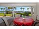 Outdoor seating area with patio furnishings, offering peaceful views of the waterfront at 9815 Harrell Ave # 503, Treasure Island, FL 33706