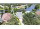 An aerial view of the home surrounded by lush landscaping and a pond at 10357 Lightner Bridge Dr, Tampa, FL 33626