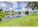 Scenic view of backyard overlooking a pond under a partly cloudy sky at 10357 Lightner Bridge Dr, Tampa, FL 33626