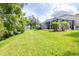Lush green backyard with a screened-in lanai and beautiful landscaping at 10357 Lightner Bridge Dr, Tampa, FL 33626