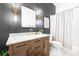 Elegant bathroom with dark accent wall, modern lighting, vanity with gold hardware, and walk-in shower at 10357 Lightner Bridge Dr, Tampa, FL 33626