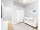 Bright bedroom features a crib, closet, wood floors, and modern decor at 10357 Lightner Bridge Dr, Tampa, FL 33626