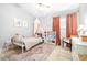 Charming bedroom with play kitchen, area rug, and canopy bed at 10357 Lightner Bridge Dr, Tampa, FL 33626
