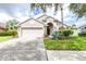 Charming single-story home with a well-manicured lawn, mature landscaping and a two car garage at 10357 Lightner Bridge Dr, Tampa, FL 33626