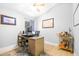 This office boasts a modern desk setup, wood floors, and a bar cart at 10357 Lightner Bridge Dr, Tampa, FL 33626