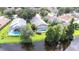 Gorgeous backyard featuring a screened pool enclosure with direct water access and a neatly manicured lawn at 10357 Lightner Bridge Dr, Tampa, FL 33626
