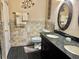 Bathroom boasts double sinks with granite counters, decorative tile, and modern fixtures at 10607 Boyette Creek Blvd, Riverview, FL 33569