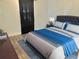 Bedroom with luxury vinyl flooring, a tufted headboard, and a stylish blue accent blanket at 10607 Boyette Creek Blvd, Riverview, FL 33569