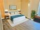 Cozy bedroom with a soft rug, wood floors, natural light, and modern decor at 10607 Boyette Creek Blvd, Riverview, FL 33569