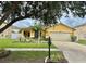 Inviting single-story home enhanced by mature landscaping and a manicured front lawn at 10607 Boyette Creek Blvd, Riverview, FL 33569