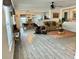 Bright living room with an open floor plan, featuring laminate floors and a comfortable seating area at 10607 Boyette Creek Blvd, Riverview, FL 33569