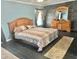 Comfortable primary bedroom with a king-sized bed, wood dresser, and brick accent wall at 10607 Boyette Creek Blvd, Riverview, FL 33569