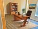 Office with a large desk, a bookcase, luxury vinyl tile flooring, and a comfortable chair at 10607 Boyette Creek Blvd, Riverview, FL 33569