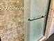 Beautifully tiled shower area with glass doors and a convenient grab bar for safety at 10607 Boyette Creek Blvd, Riverview, FL 33569