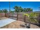 A backyard features a modern wooden fence, palm tree, concrete driveway, and secure gate at 1101 Essex N Dr, St Petersburg, FL 33710