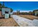 A backyard with a wooden playhouse and a concrete driveway provides outdoor space for recreation and activities at 1101 Essex N Dr, St Petersburg, FL 33710