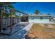 Backyard with a deck, seating area, and fire pit, ideal for outdoor living at 1101 Essex N Dr, St Petersburg, FL 33710