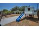 Backyard features a modern playhouse with slide and a grassy lawn at 1101 Essex N Dr, St Petersburg, FL 33710